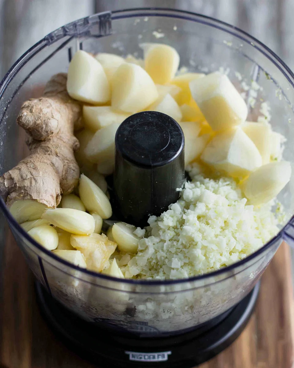 Butter Chicken Ingredient Preparation Butter chicken preparation with garlic, onion, and ginger.