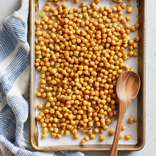 Crispy roasted chickpeas on a baking sheet for snacking