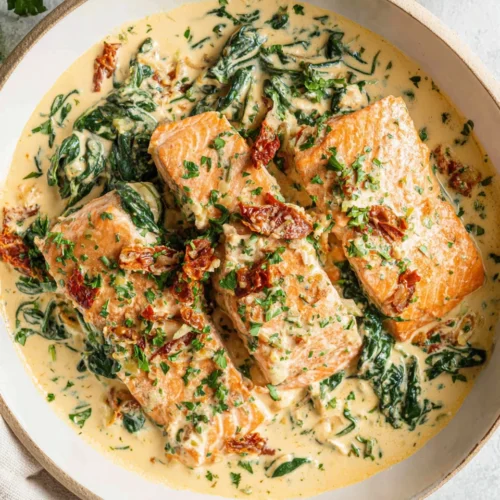 Keto Tuscan salmon in a creamy sauce with spinach.