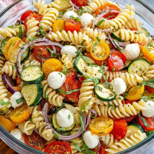 Delicious pasta salad with fresh vegetables and mozzarella.