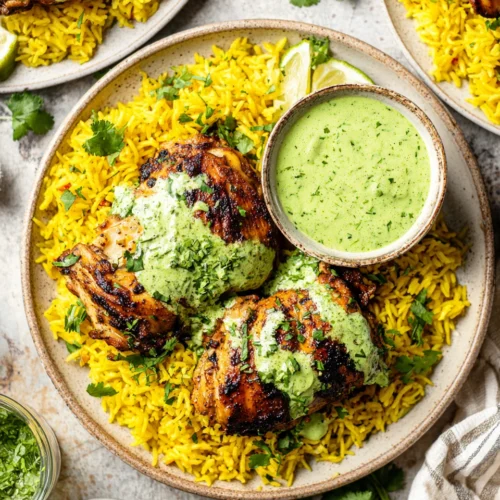 Delicious Peruvian chicken served with yellow rice and green sauce.