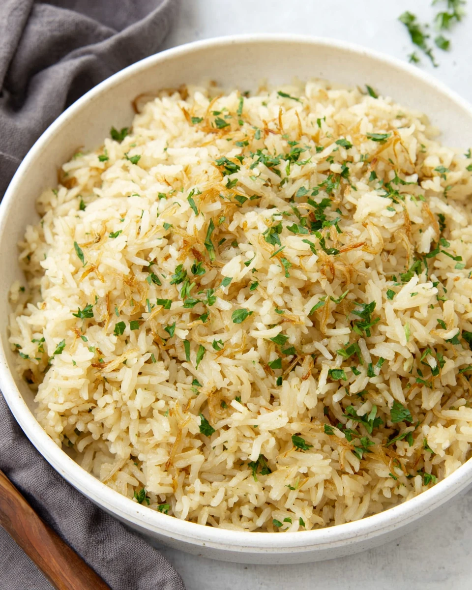 Delicious rice pilaf with vermicelli and parsley garnish.