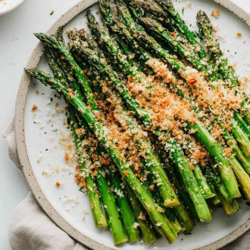 Delicious roasted asparagus topped with cheese and breadcrumbs.