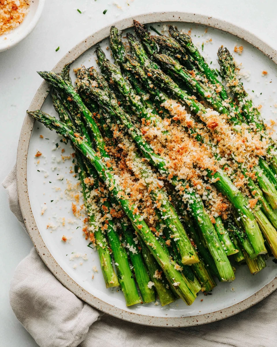 Delicious roasted asparagus topped with cheese and breadcrumbs.