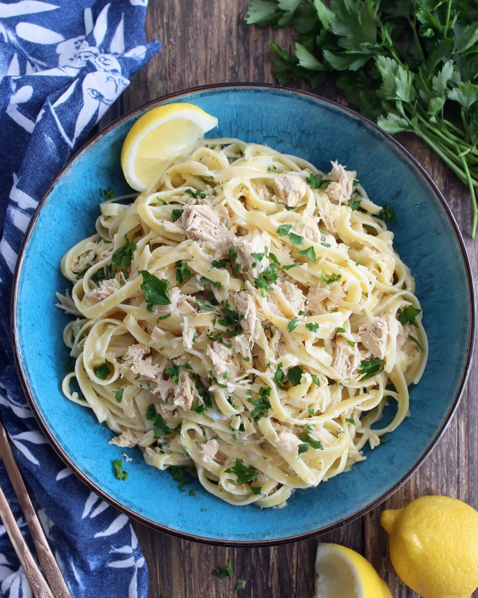 Tuna pasta dish garnished with parsley and lemon