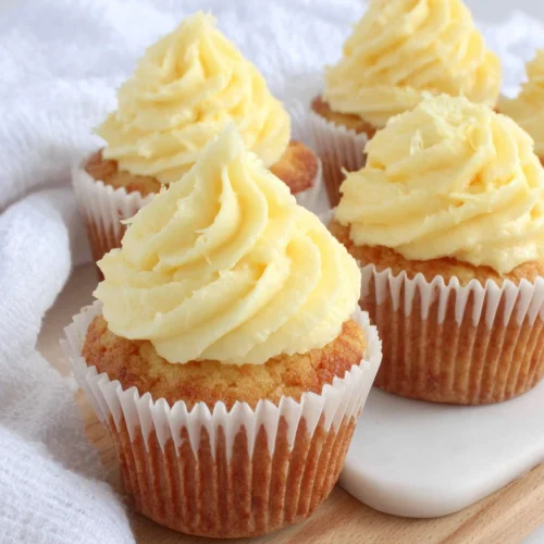 Delicious vanilla cupcakes topped with creamy frosting.