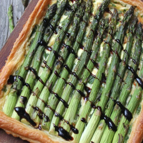Savory asparagus tart highlights fresh ingredients and flaky pastry.