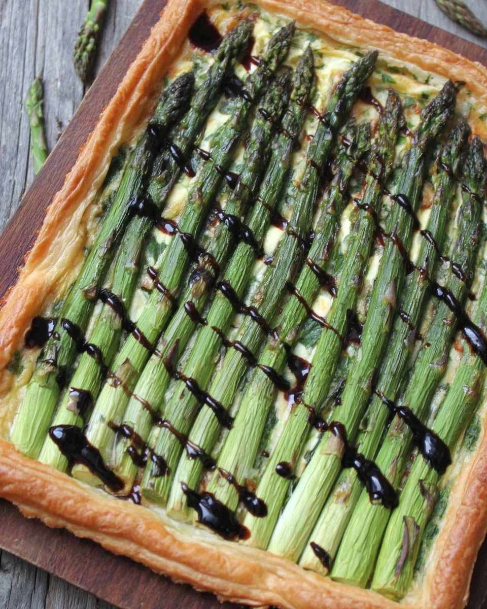 Savory asparagus tart highlights fresh ingredients and flaky pastry.