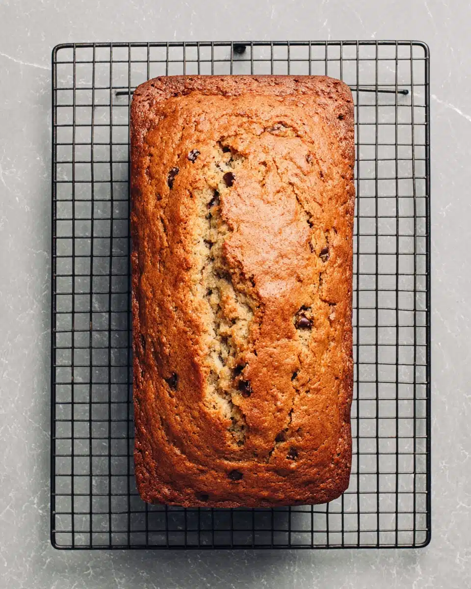 Delicious banana chocolate chip bread on a cooling rack.