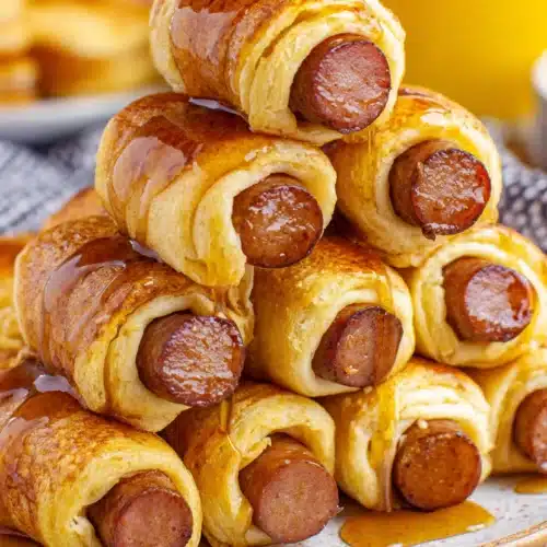 Delicious Breakfast Pigs in a Blanket for Easy Mornings 1 Breakfast pigs in a blanket with sweet syrup, perfect for mornings.