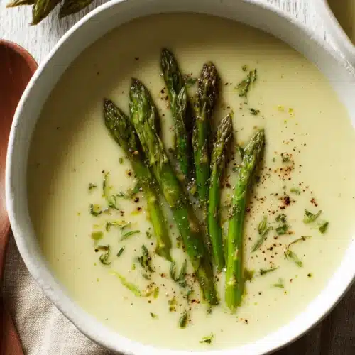 Cream of asparagus soup with fresh asparagus spears.