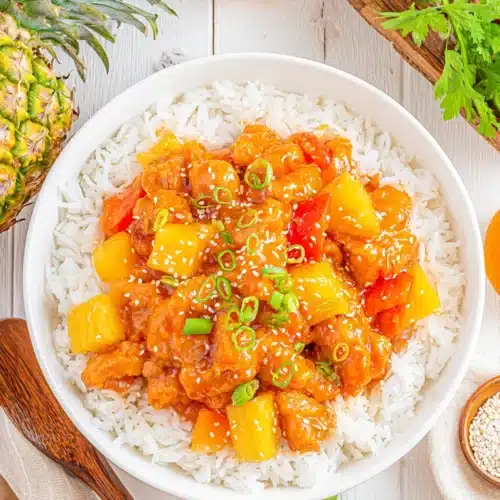 Hawaiian pineapple chicken served over rice, featuring vibrant colors.