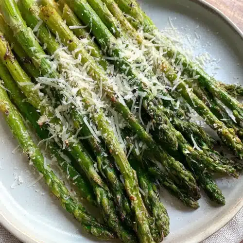 Oven roasted garlic parmesan asparagus on plate.