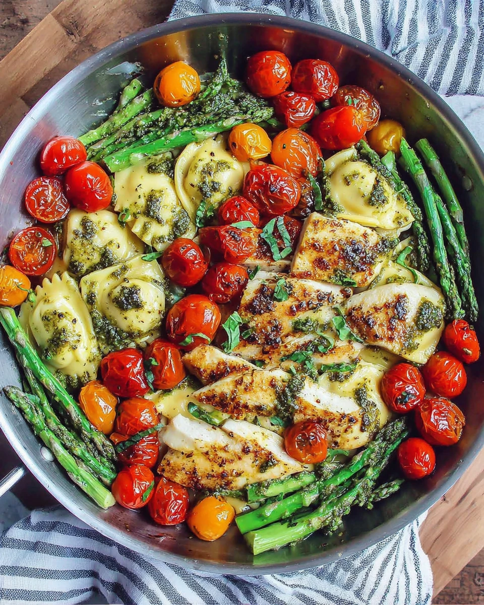 Delicious pesto ravioli with chicken and veggies for dinner.
