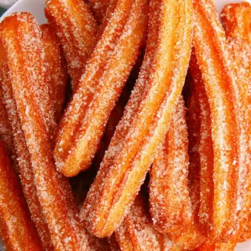 Authentic churros coated in cinnamon sugar - crispy and soft