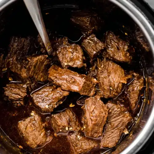 Delicious beef barbacoa simmering in a savory sauce