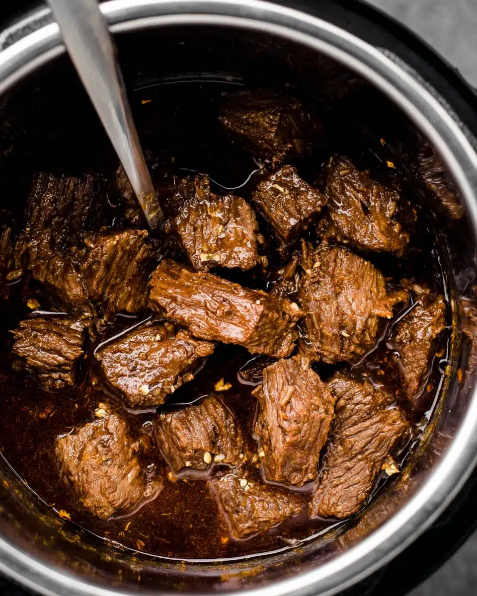 Delicious beef barbacoa simmering in a savory sauce