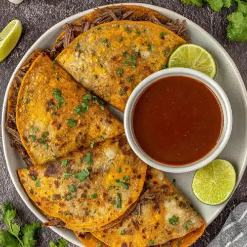 Birria consome sauce and tacos for a delightful meal.