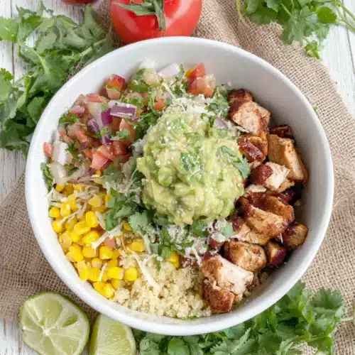 Chipotle chicken bowl with vibrant fresh toppings and cilantro lime rice.