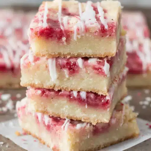 Delicious classic lemon bars topped with strawberry glaze.