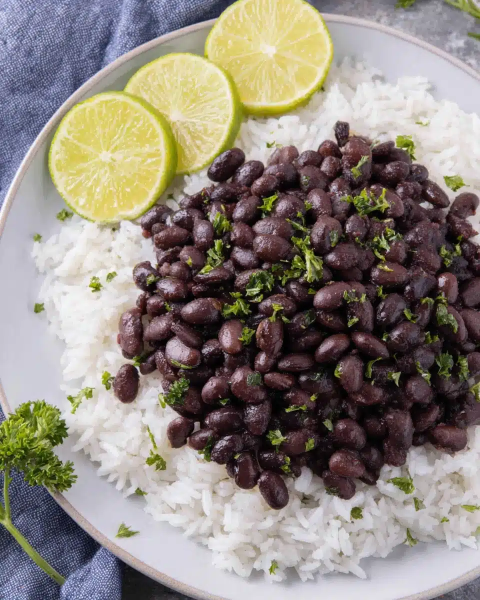 Cuban style black beans served over white rice with parsley.