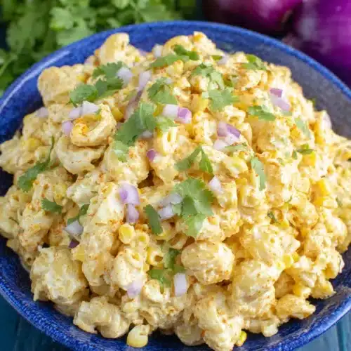 Delicious Mexican street corn pasta salad in a blue bowl.