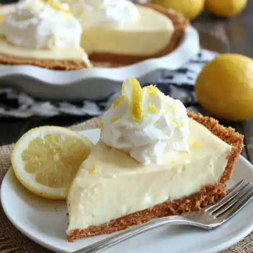 Paula Deen lemon pie topped with whipped cream and lemon zest