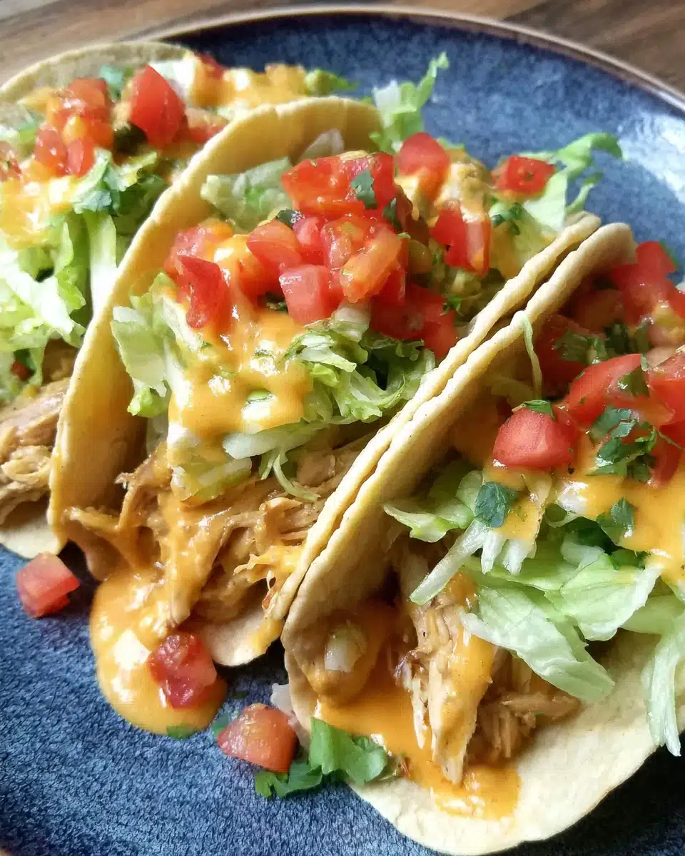 Slow Cooker Queso Chicken Tacos Recipe Delicious slow cooker queso chicken tacos with fresh toppings.