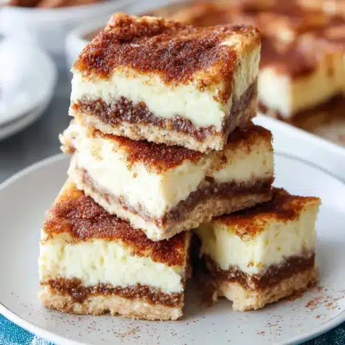 Delicious sopapilla cheesecake with creamy layers and cinnamon topping.
