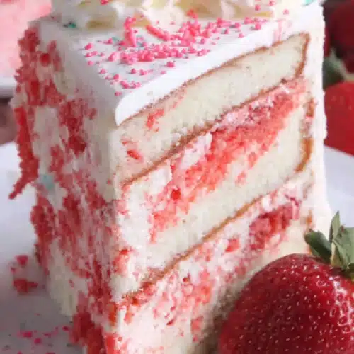 Strawberry shortcake ice cream cake with layers of cake, ice cream, and fresh strawberries