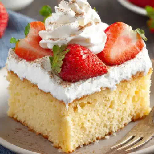 Delicious tres leches cake slice with strawberries.