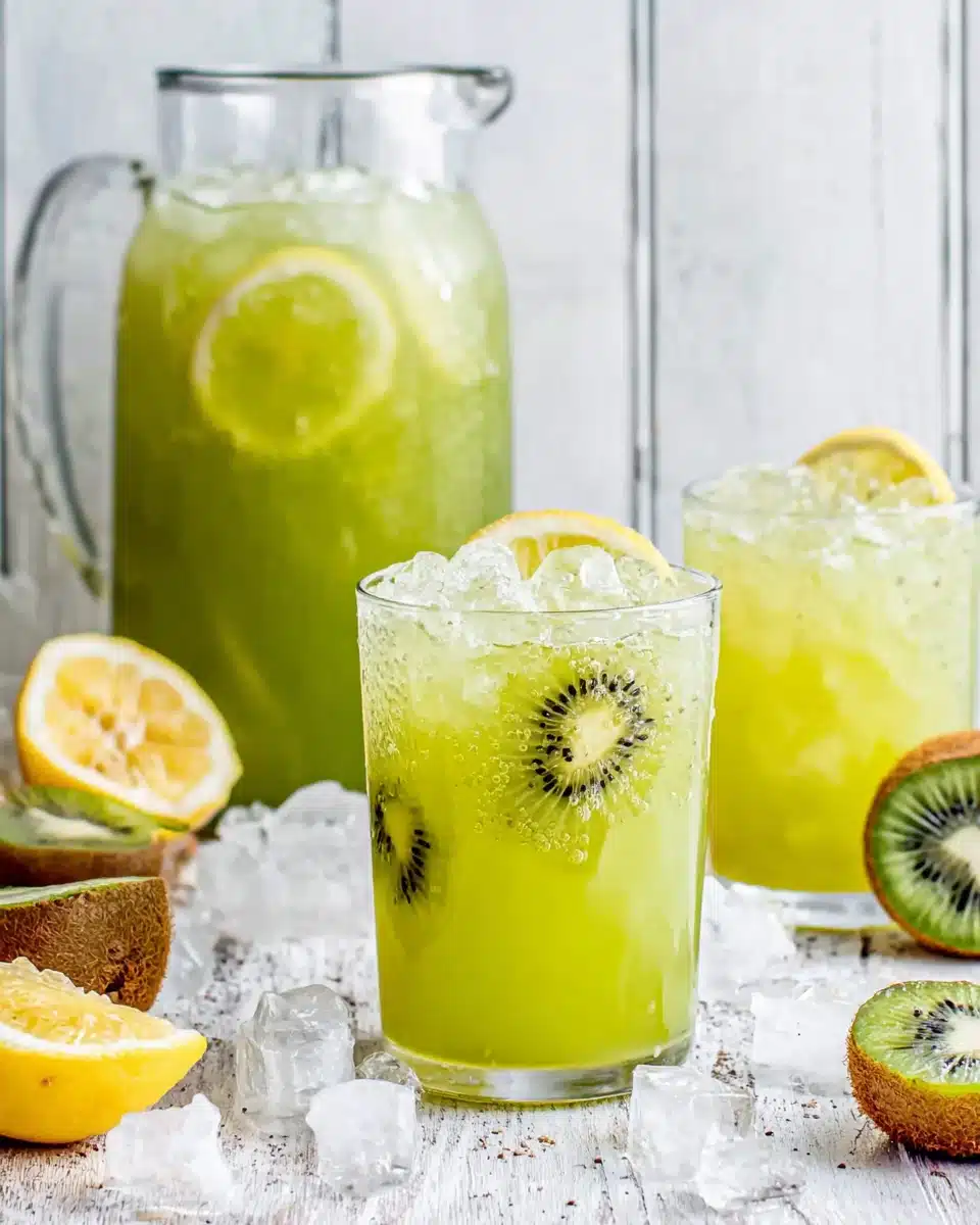 Agua de kiwi in a pitcher and glasses with lemon and ice