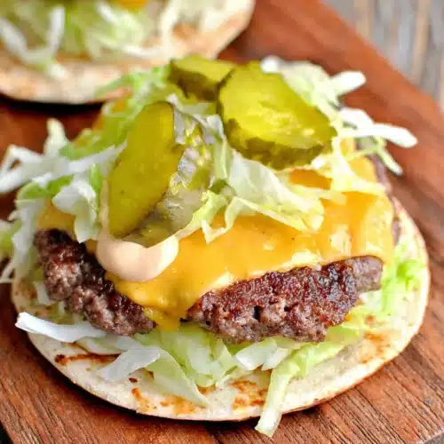 Keto Big Mac smash burger with cheese, pickles, and lettuce on a zero-carb tortilla