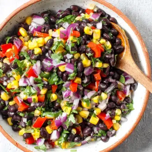 Black bean and corn salad with red pepper, corn, cilantro, and lime in a bowl