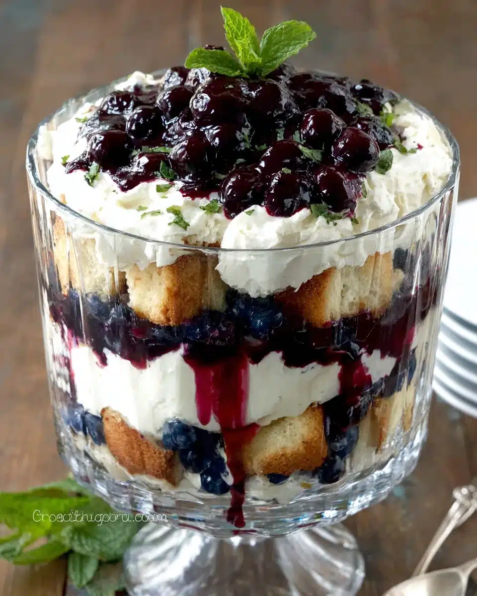 Blueberry Cheesecake Trifle with Creamy Layers and Fresh Blueberries Blueberry cheesecake trifle with layers of cake, cream, and blueberry filling in a glass bowl