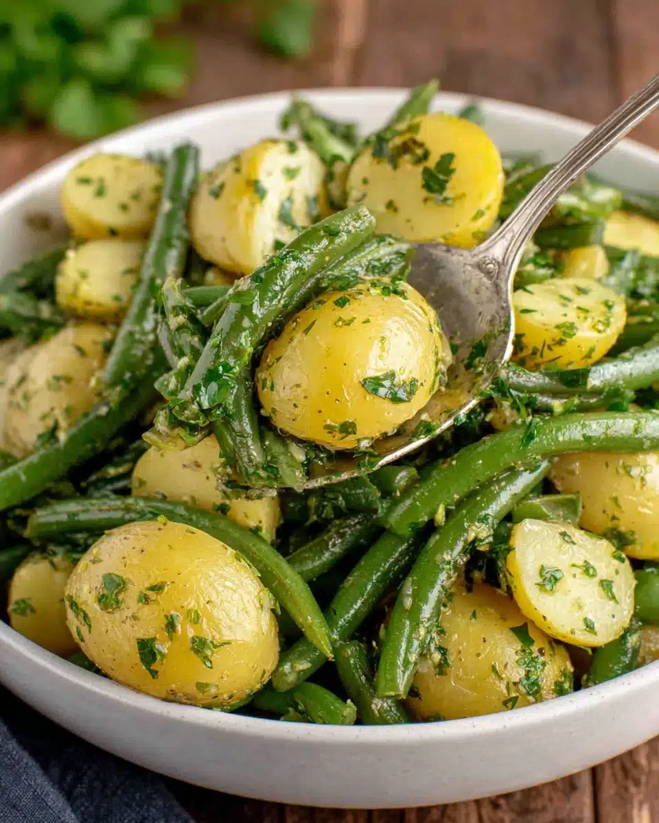 Creamy green bean potato salad with potatoes and green beans in a white bowl