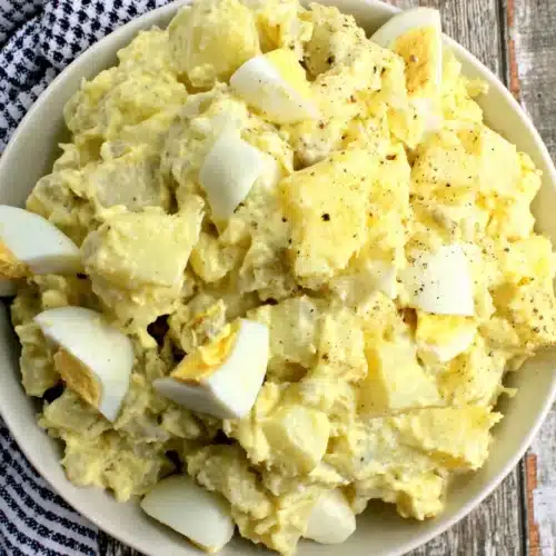 Easy Southern Potato Salad Recipe: Creamy and Irresistible! 1 Creamy southern potato salad with hard-boiled eggs in a white bowl