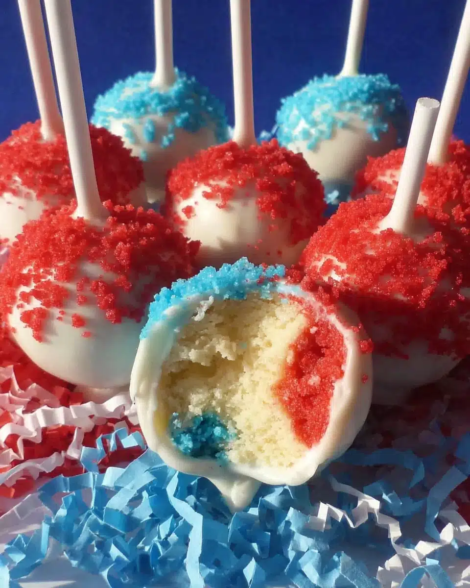 Festive Fourth of July Cake Pops with Red and Blue Centers Fourth of July cake pops with red, white, and blue drizzle and colorful interiors