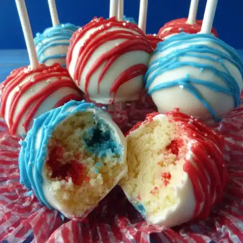 Fourth of July Cake Pops: A Festive Delight for Everyone 1 Red, white, and blue Fourth of July cake pops with drizzled chocolate and crinkle paper