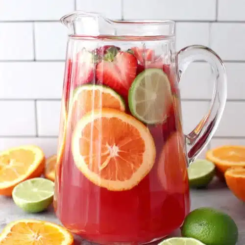 Fruit punch recipe in a pitcher with fresh fruit slices