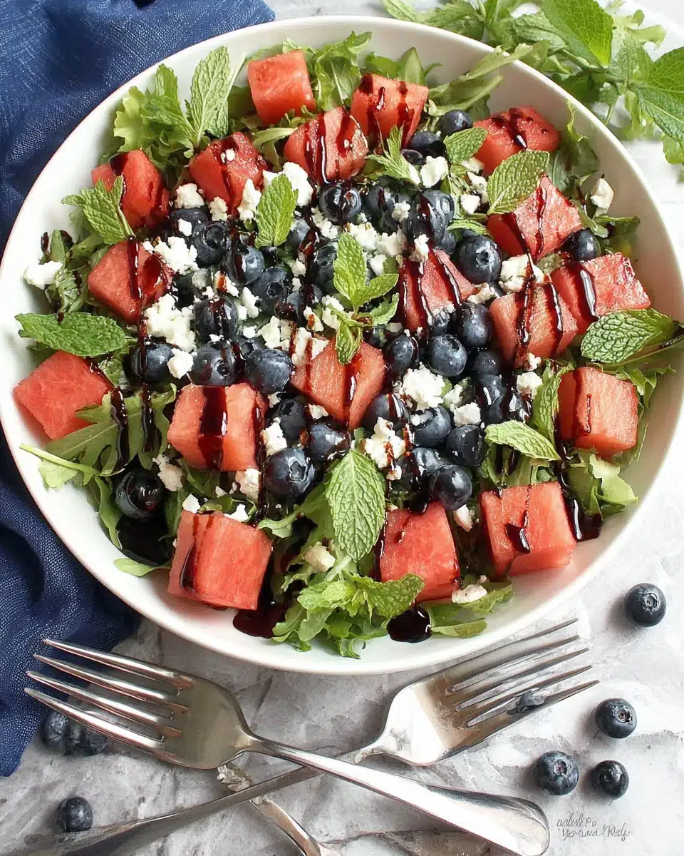July 4th salad with watermelon, blueberries, feta, and mint in a white bowl