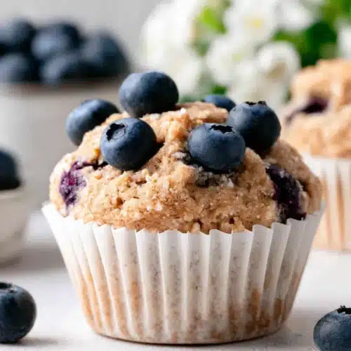 Mini Blueberry Banana Muffins: Deliciously Easy and Healthy 1 Mini blueberry banana muffin with fresh blueberries on top