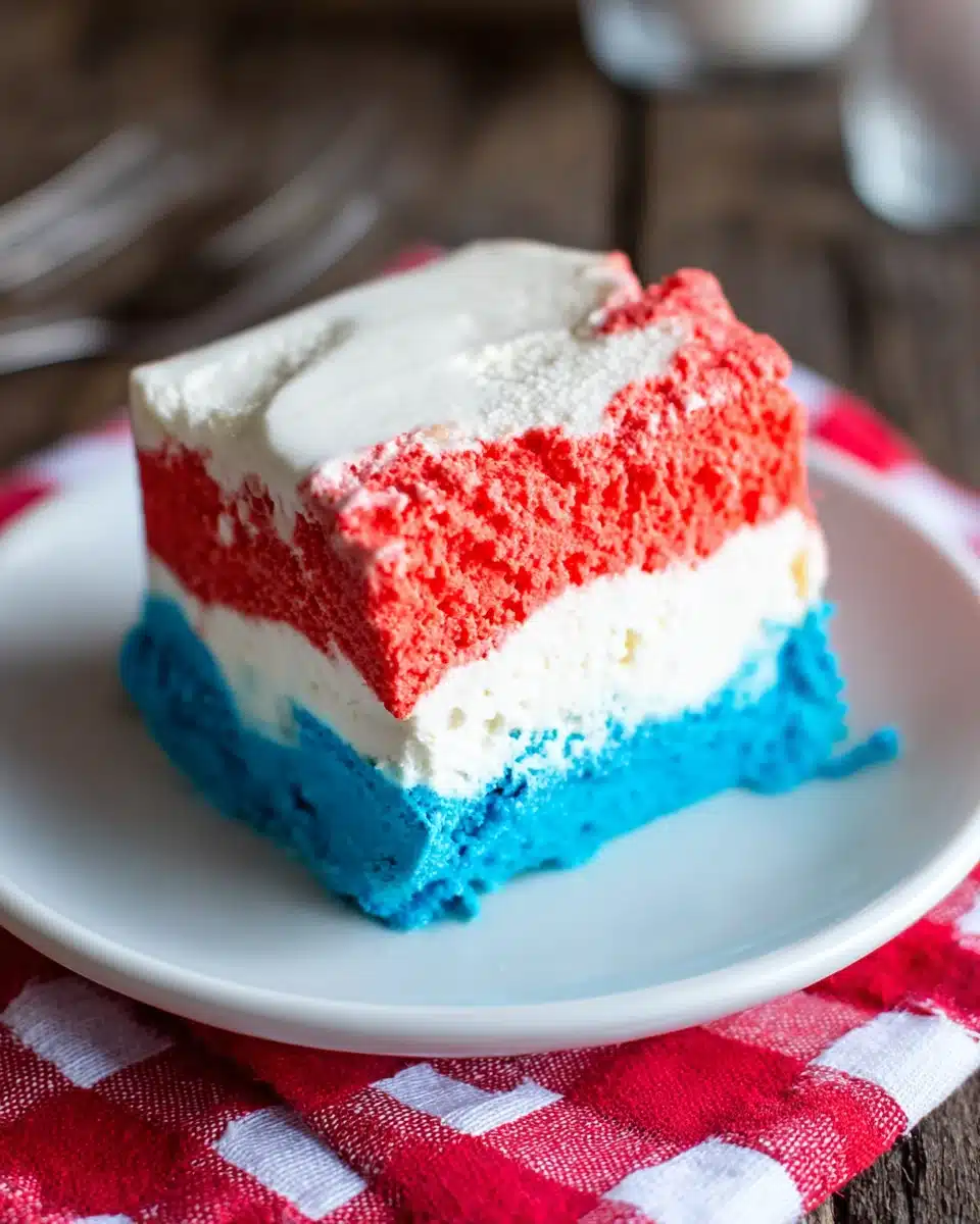 Patriotic Neapolitan ice cream slice with red, white, and blue layers on a plate
