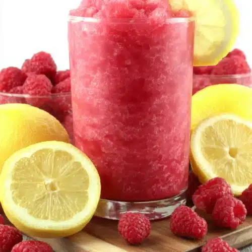 Raspberry Lemonade Slushie: A Refreshing Summer Delight 1 Refreshing raspberry lemonade slushie with lemon garnish and fresh berries