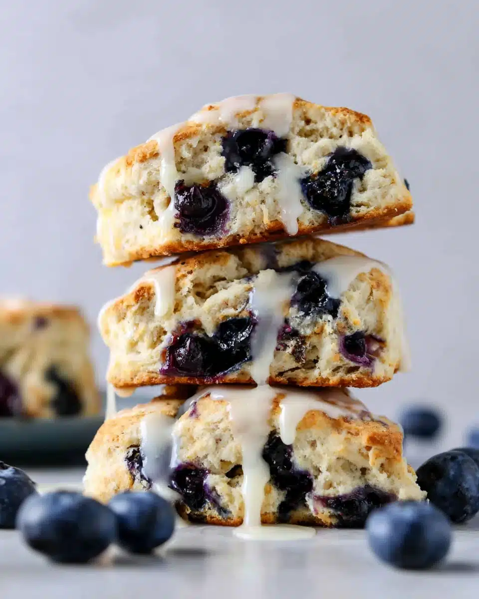 Sourdough blueberry scones stacked with vanilla glaze and fresh blueberries