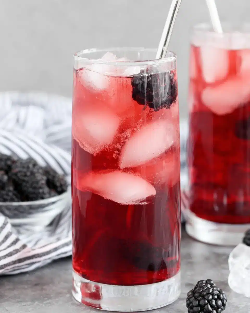 Starbucks Very Berry Hibiscus Refresher with Fresh Blackberries Starbucks Very Berry Hibiscus Refresher with blackberries and ice in a tall glass