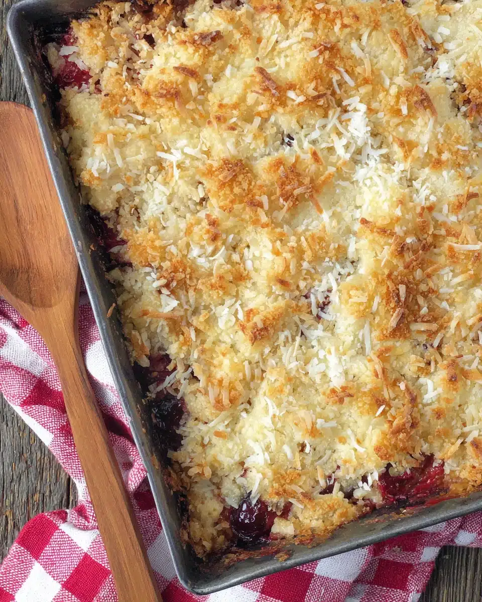 Strawberry Blueberry Gluten Free Dump Cake with Coconut Topping Strawberry blueberry gluten free dump cake with golden coconut topping in a pan