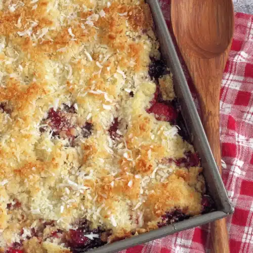 Delicious Strawberry Blueberry Gluten Free Dump Cake 1 Strawberry blueberry gluten free dump cake with golden coconut topping in a pan