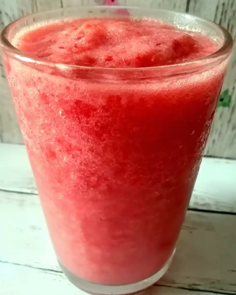 Strawberry Smoothie Surprise in a Glass Strawberry smoothie surprise in a glass with condensation, vibrant red color