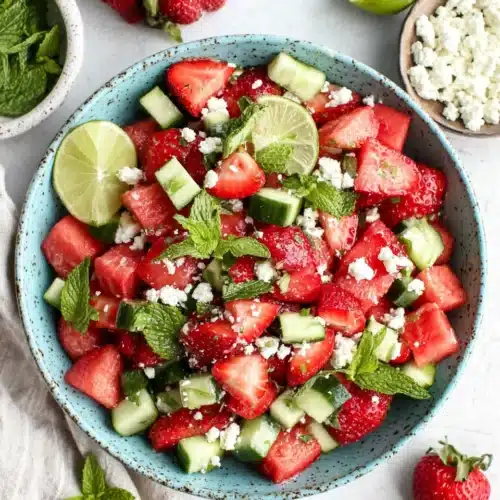 Strawberry watermelon cucumber salad with feta and mint in a ceramic bowl
